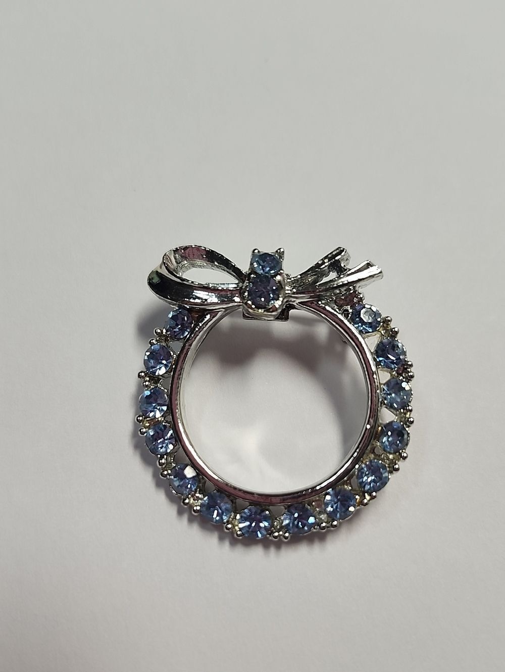 Silver Bow Circle Pendant with Light Blue Stones Wreath